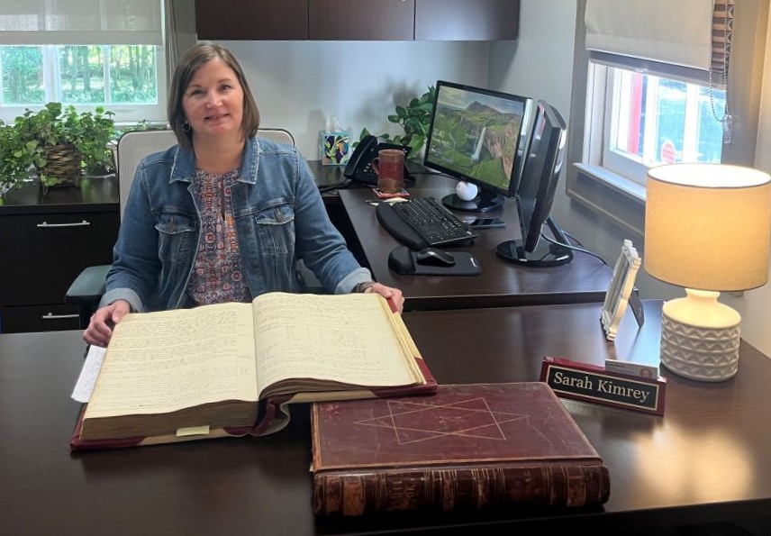 Sarah Kimrey sits at her desk, reviewing the town's oldest minutes