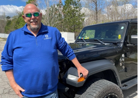 Tiny Moore Safety Director standing in front of a Jeep