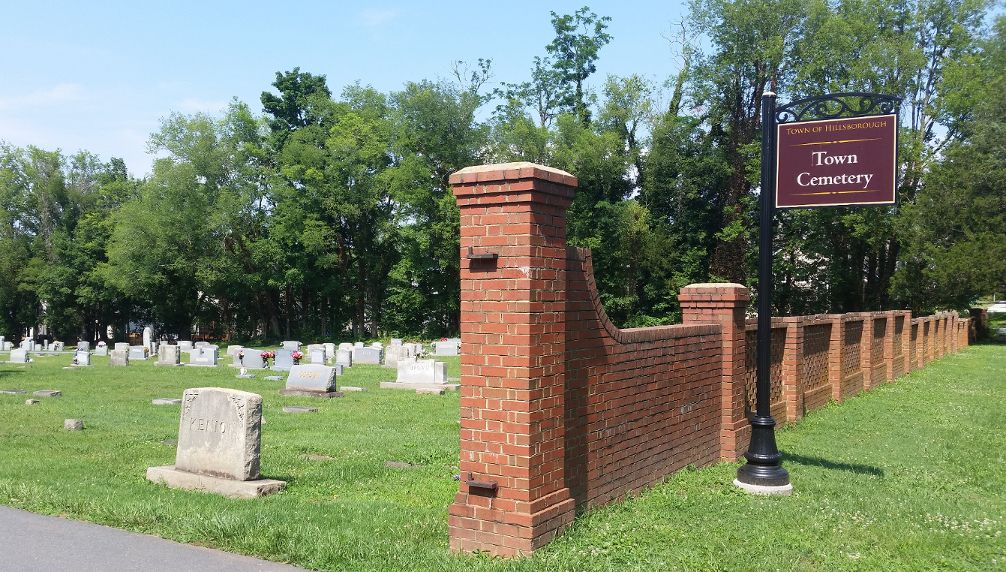 The entrance to the Town Cemetery framed by brick pillars.