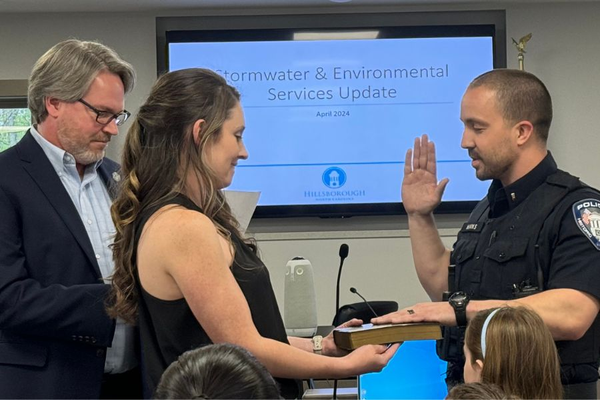 Police officer takes oath of office.