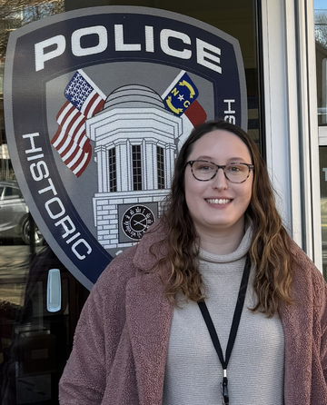 Woman standing outside glass door of police station